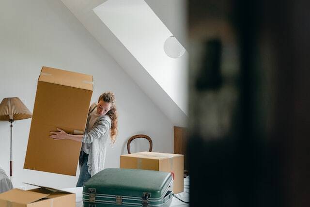 Tenant carrying a large cardboard box